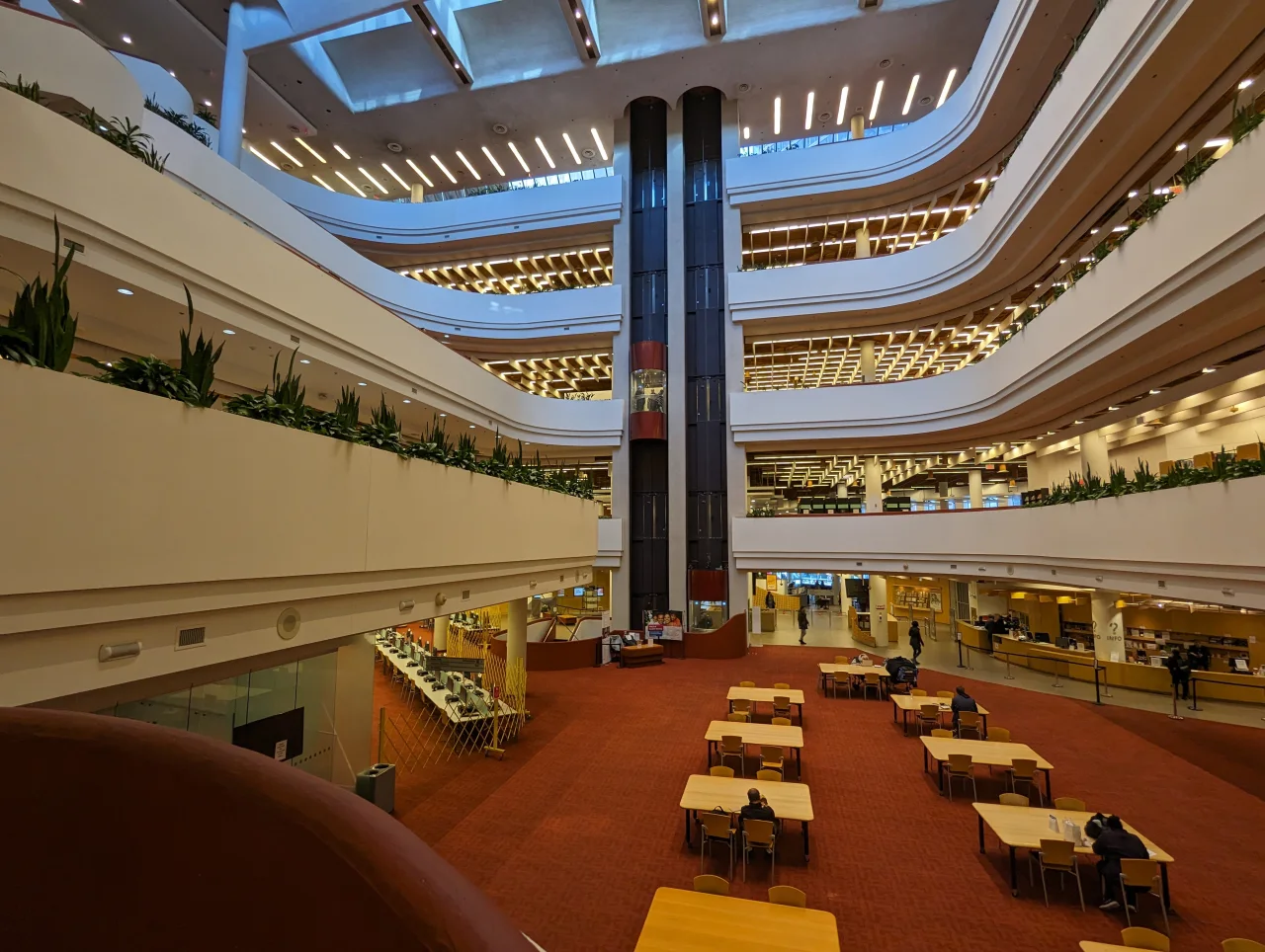 Curved levels, reading tables and a central elevator inside Toronto Reference Library.