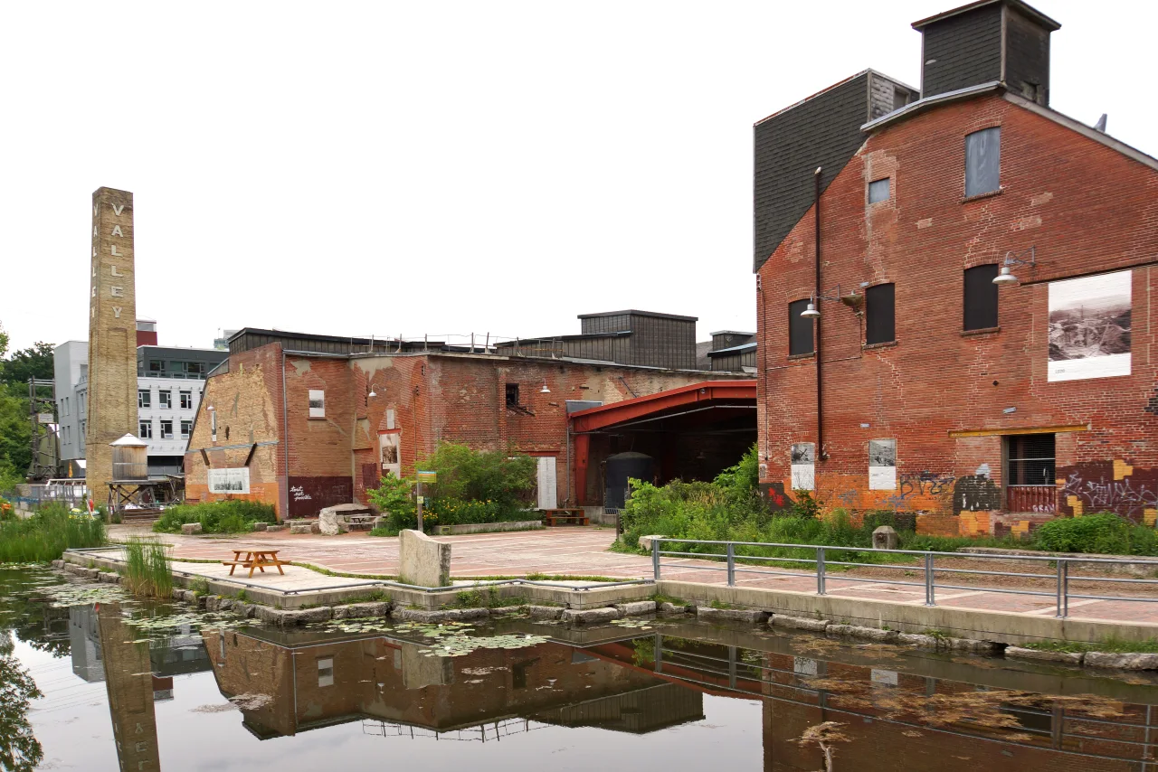 Former brick factory buildings, chimney and pond at Evergreen Brick Works.
