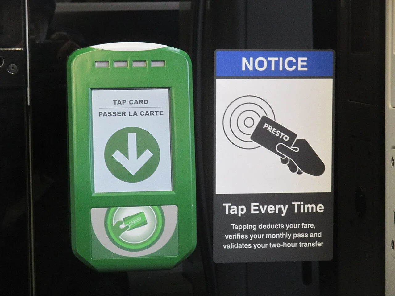 A green PRESTO reader beside a TTC streetcar notice reminding passengers to tap each time.