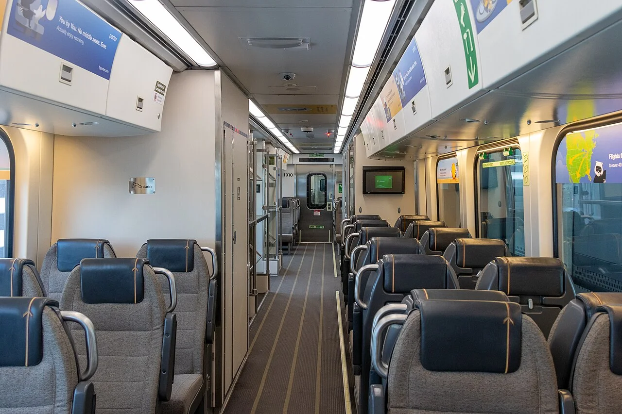 Rows of seats and the aisle inside an UP Express train.