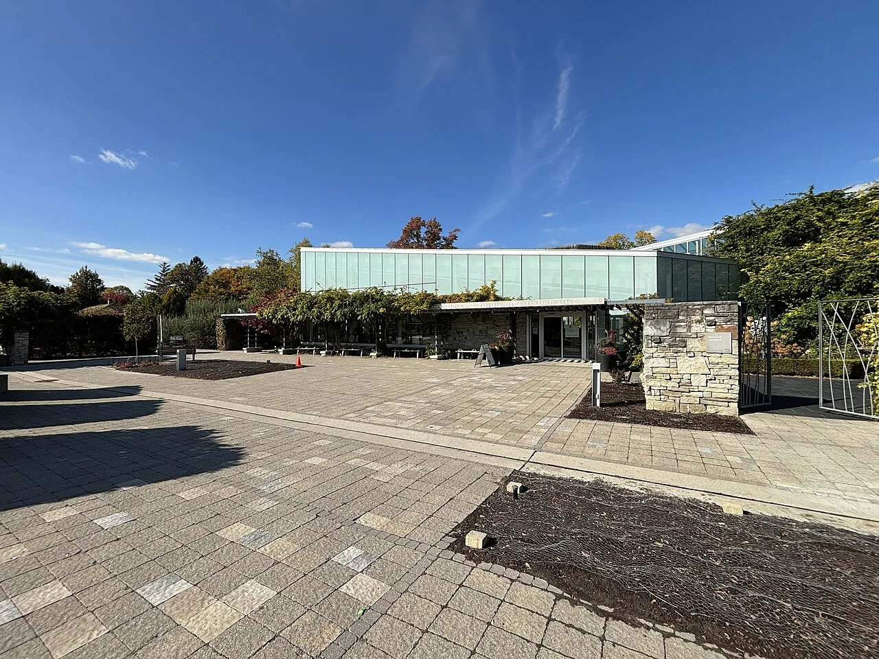The glass and stone Visitor Centre building at Toronto Botanical Garden.