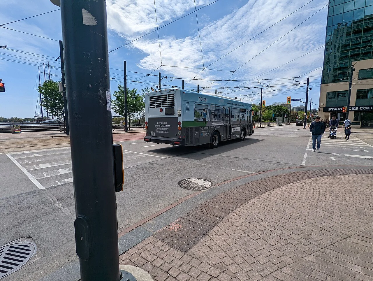 A Billy Bishop Airport shuttle bus travelling on Queens Quay West