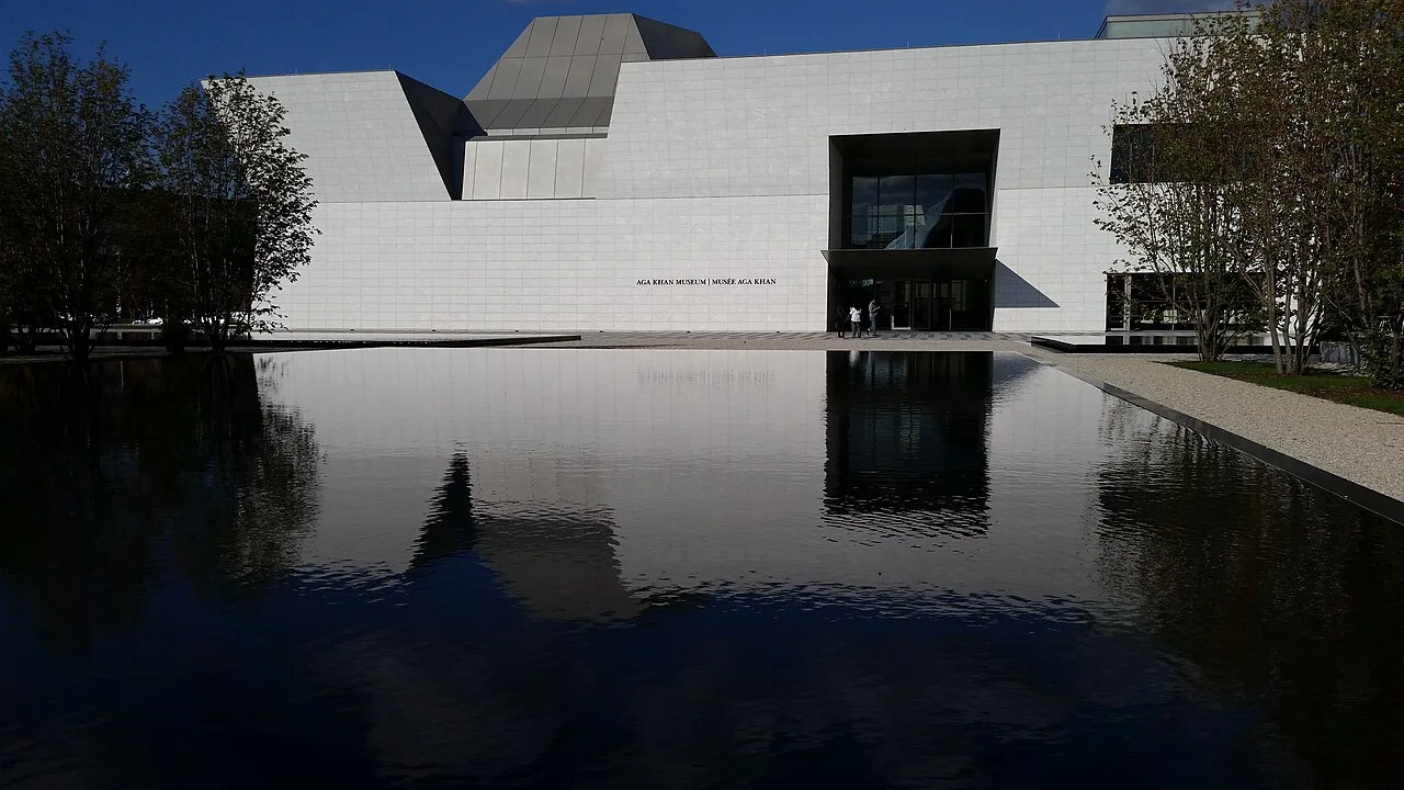Reflecting pool and pale museum façade at Aga Khan Park.