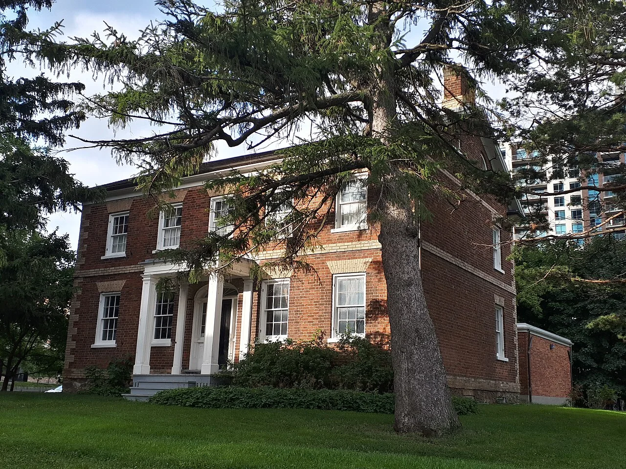 Gibson House brick exterior surrounded by trees in North York.