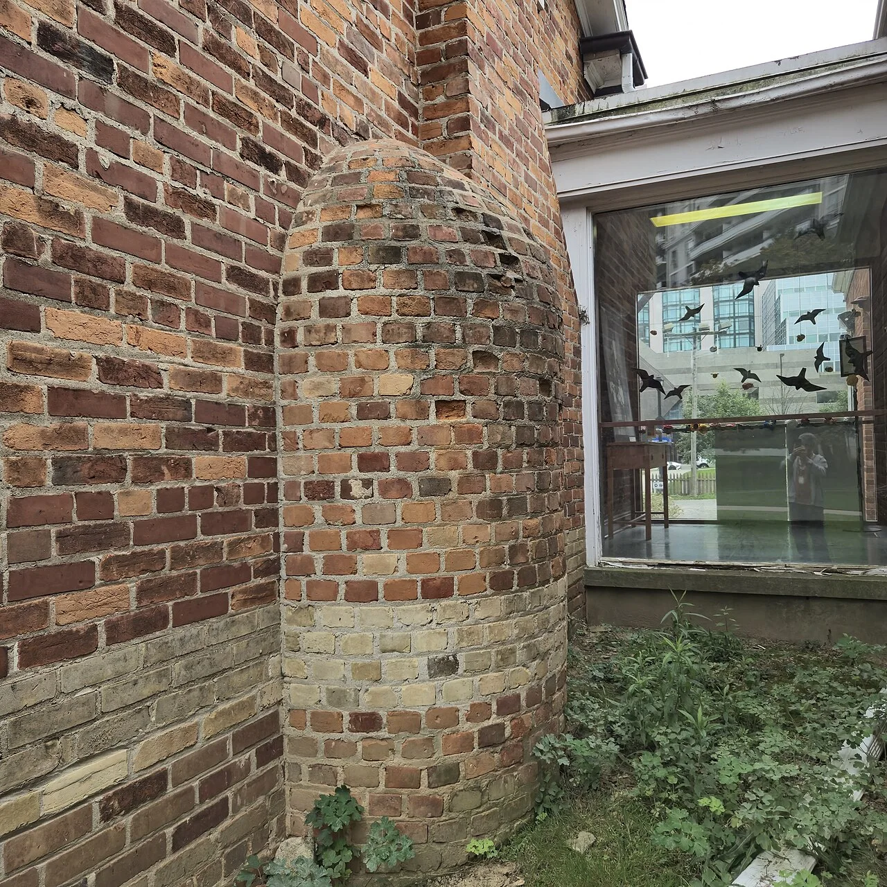 Rounded brick hearth projection on the exterior of Gibson House.