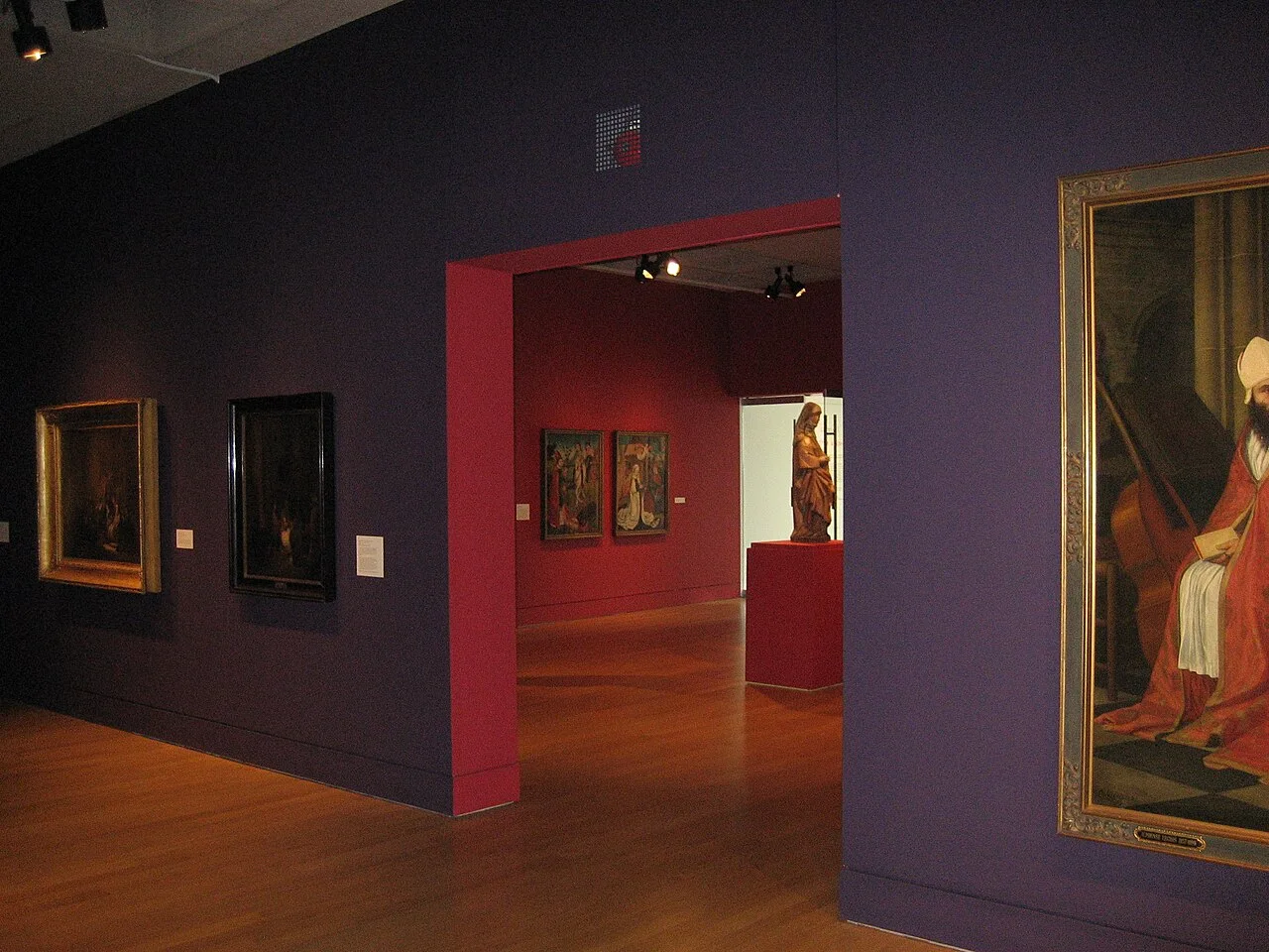 Connected gallery rooms at the Art Gallery of Hamilton with historic paintings.