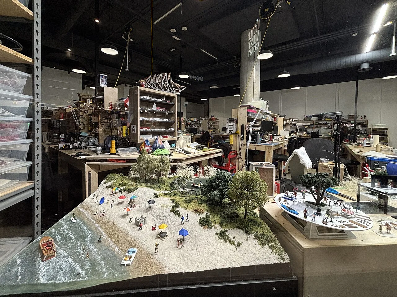Miniature Maker’s Studio with small scenes, worktables and model-making supplies.