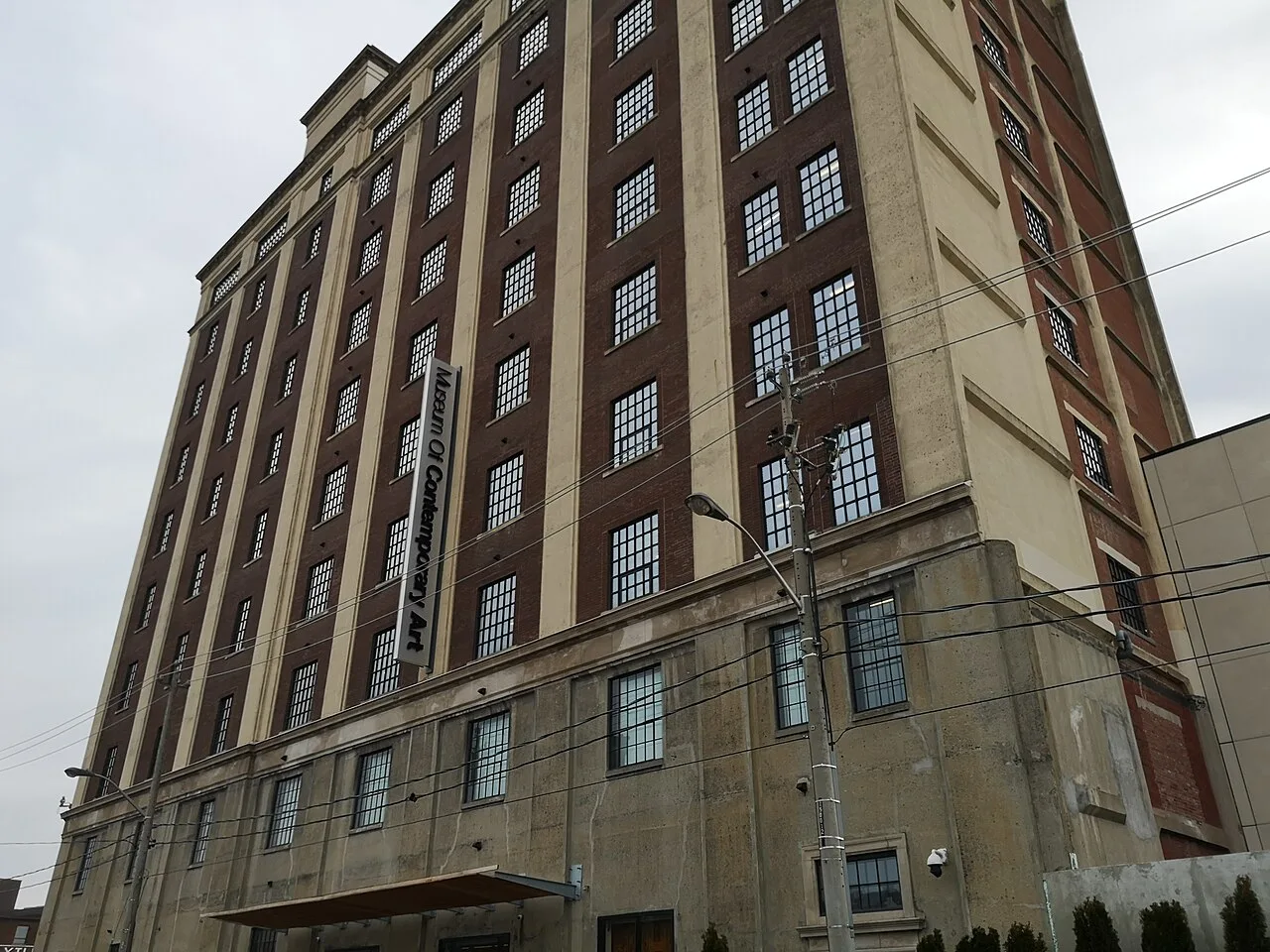 Upper façade of the Tower Automotive Building with MOCA signage.