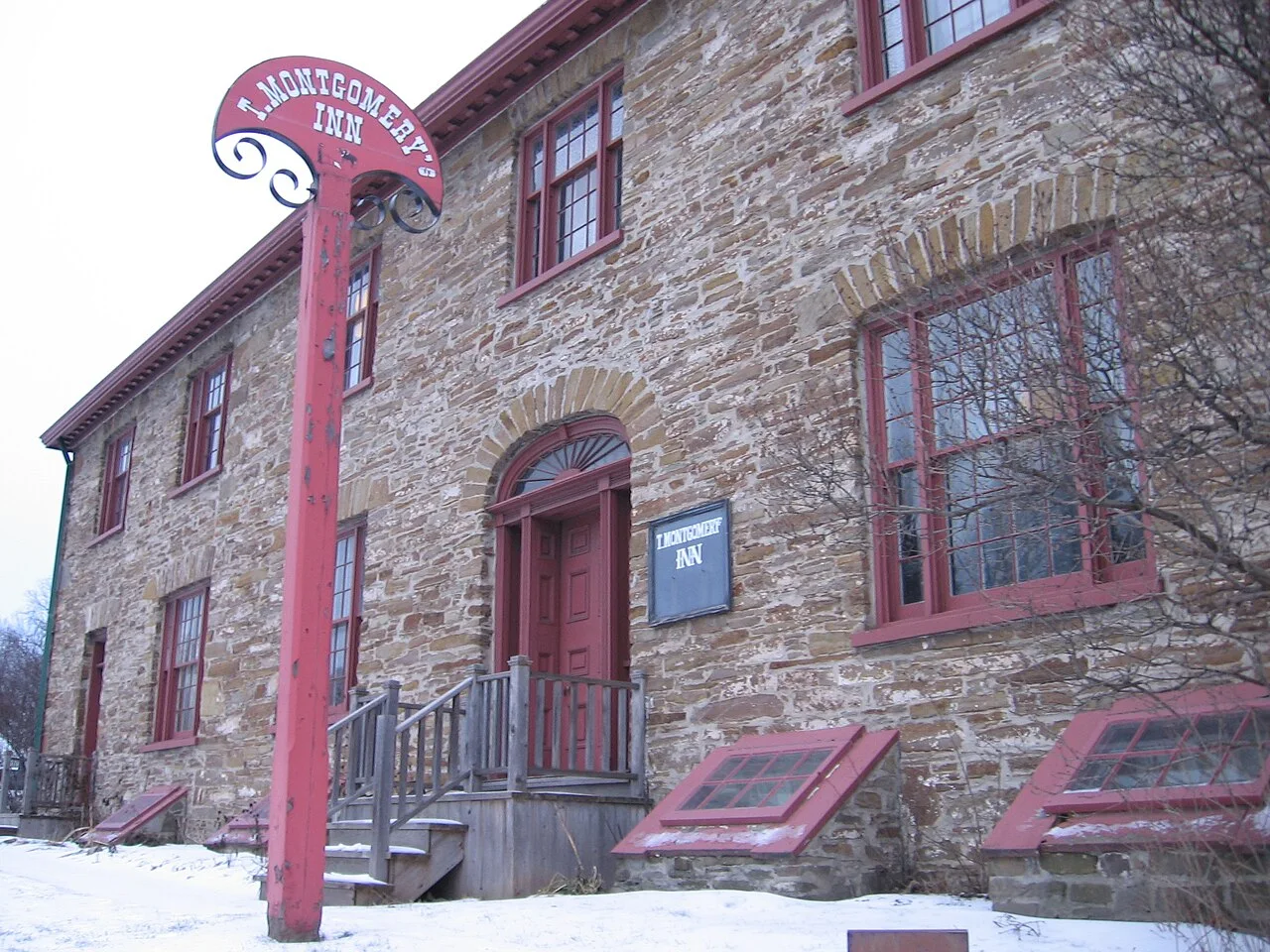 Montgomery’s Inn exterior and sign in winter.
