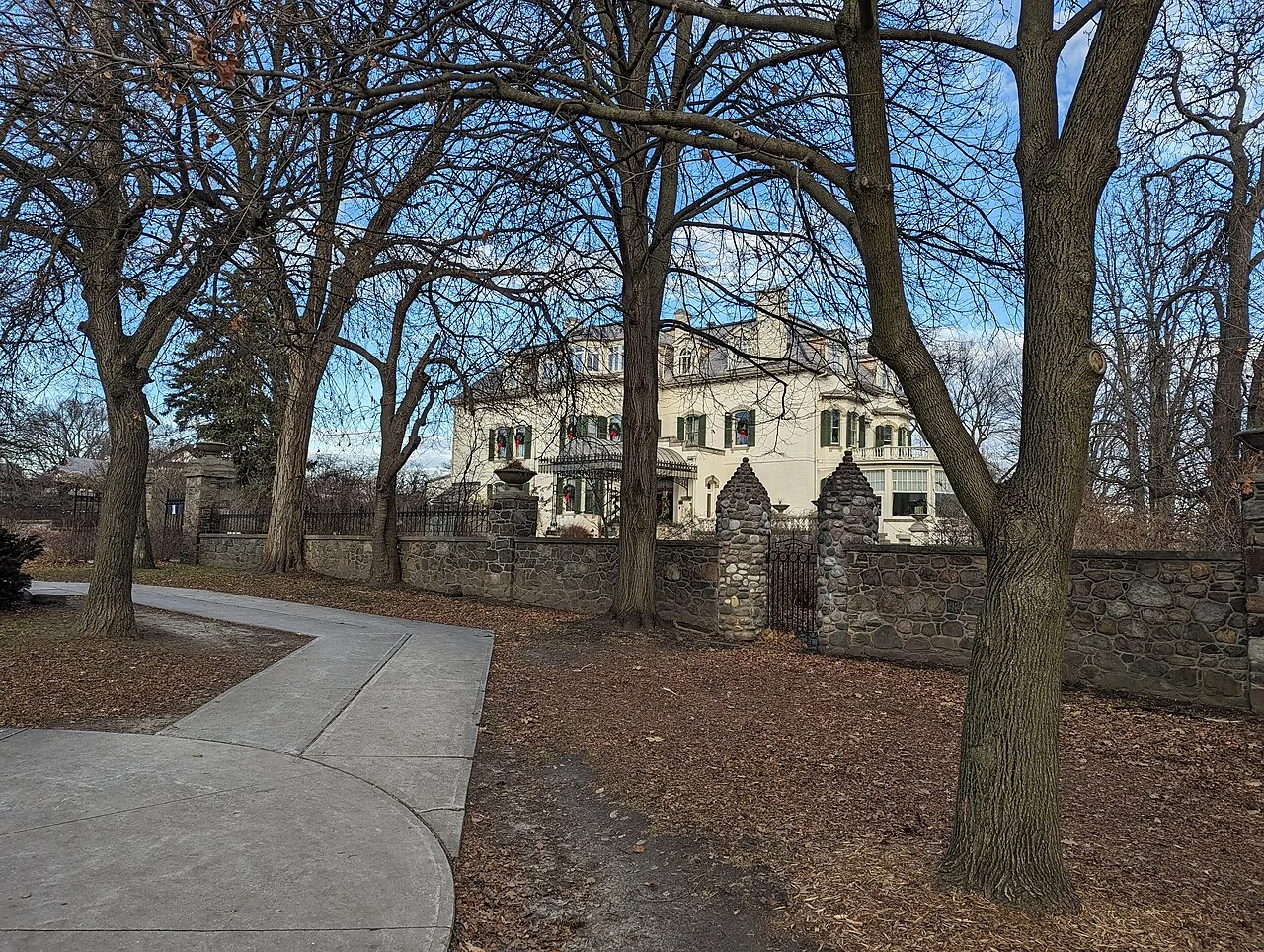 Spadina Museum grounds and house behind the boundary in winter.