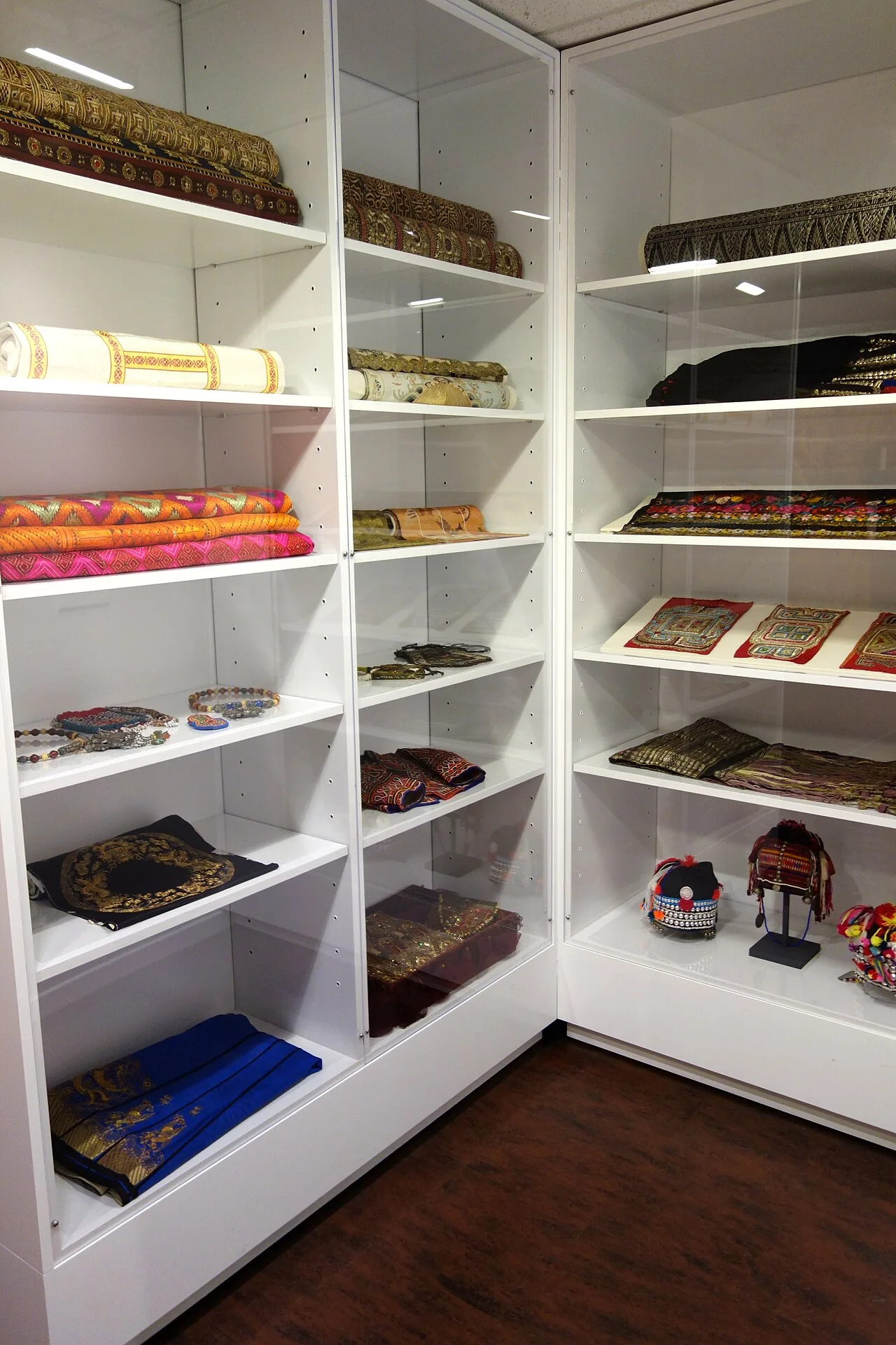 A cabinet of textiles and related objects at the Textile Museum of Canada.