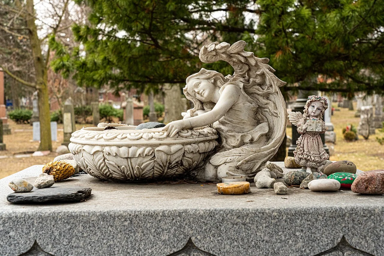 Angel memorial and surrounding gravestones at Toronto Necropolis