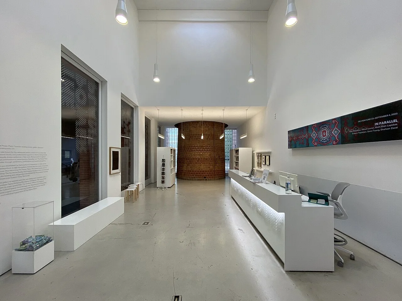 The Power Plant gallery reception area with a desk and brick chimney