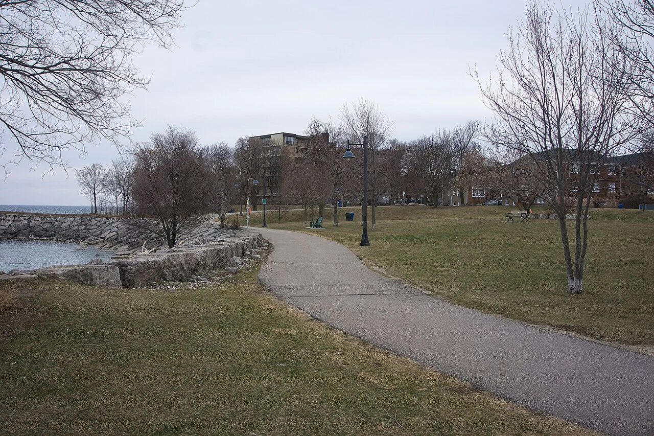 Curving paved pathway beside the water in Mimico Waterfront Park