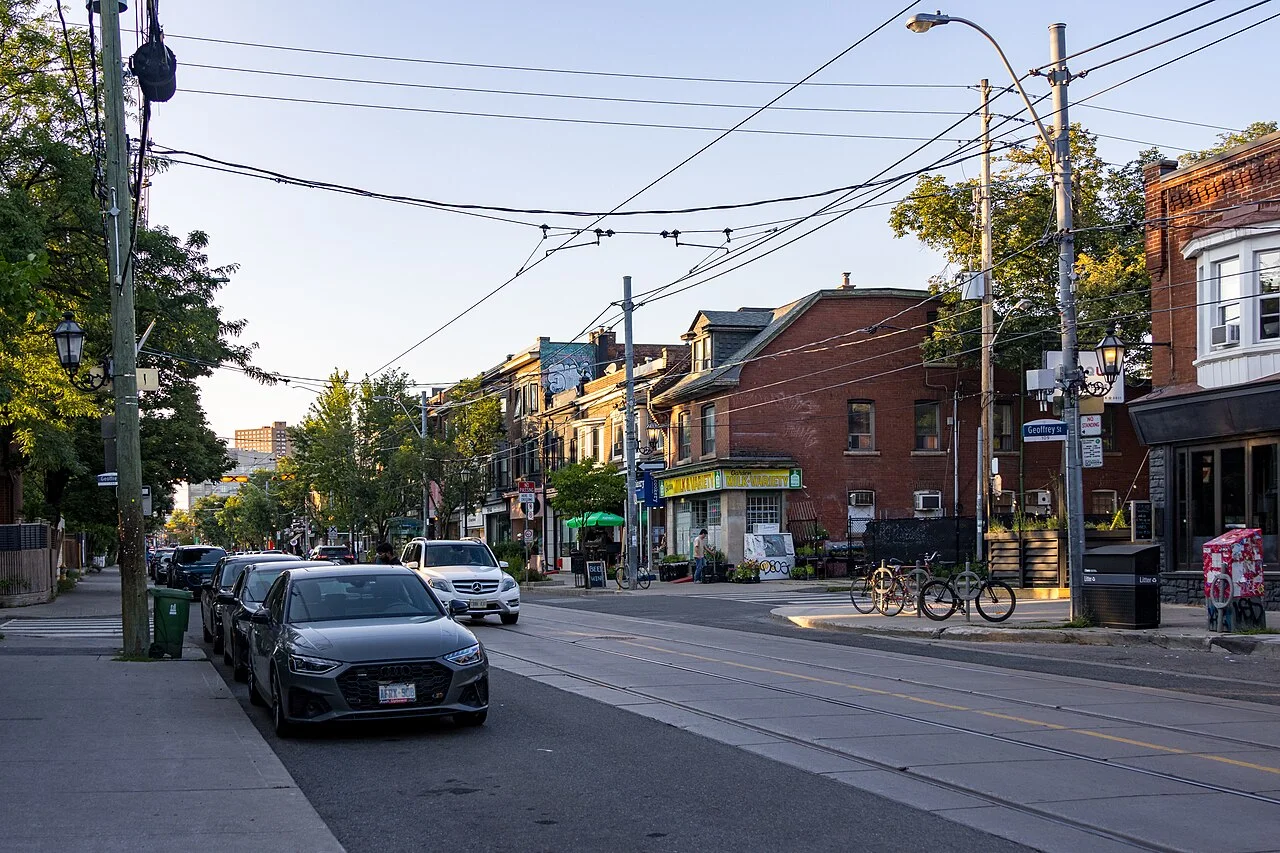 Roncesvalles Avenue at Geoffrey Street with shops and streetcar tracks
