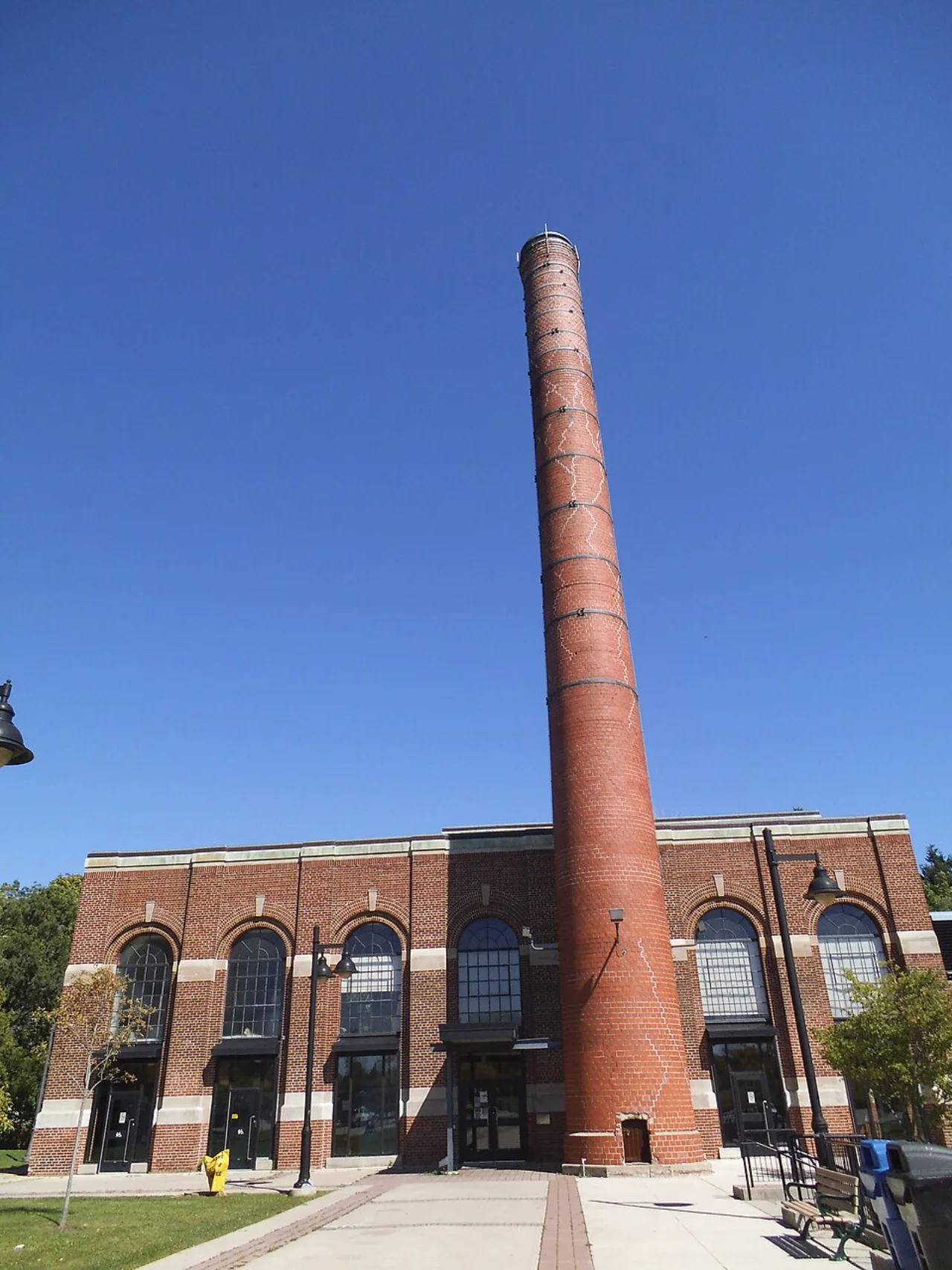 A red-brick powerhouse building and tall chimney at Colonel Samuel Smith Park.