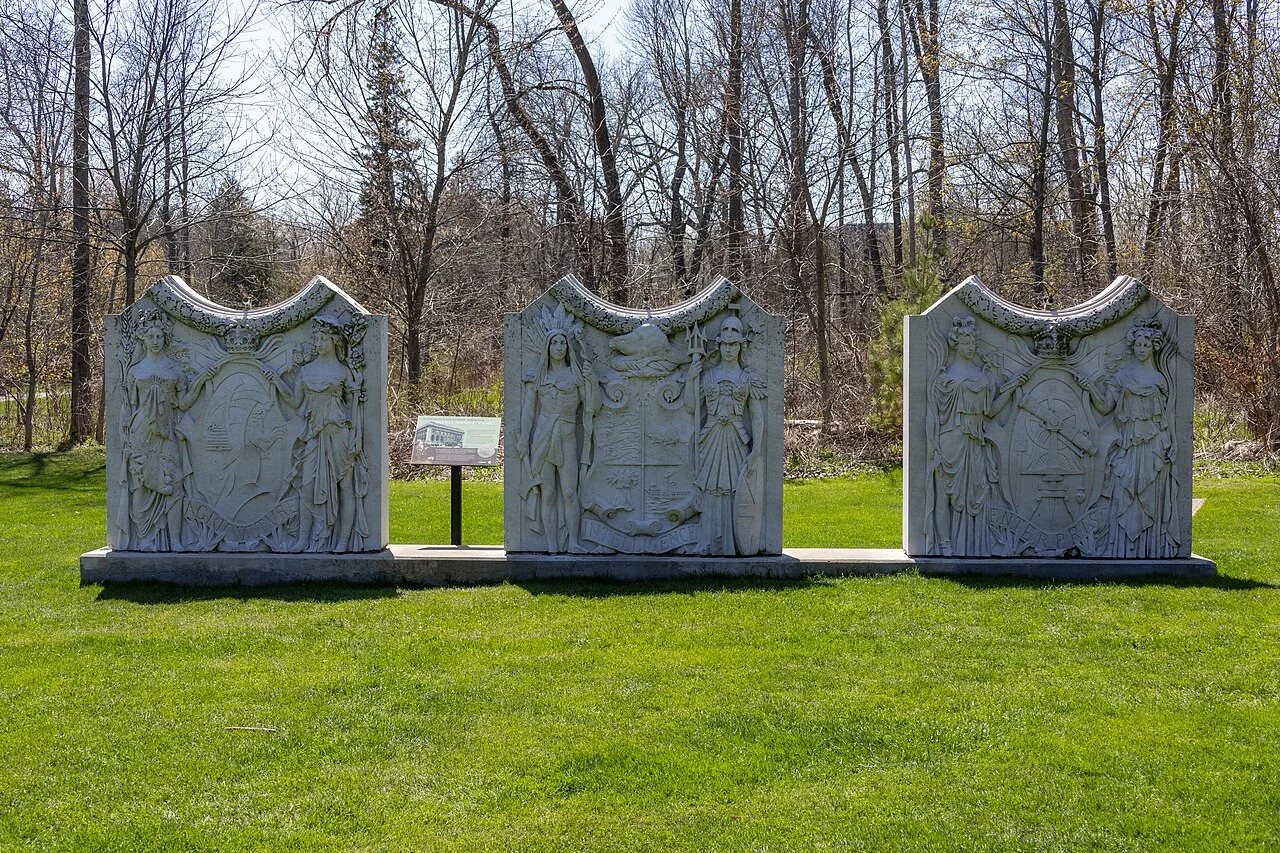 Architectural stone panels standing in a wooded clearing at Guild Park.