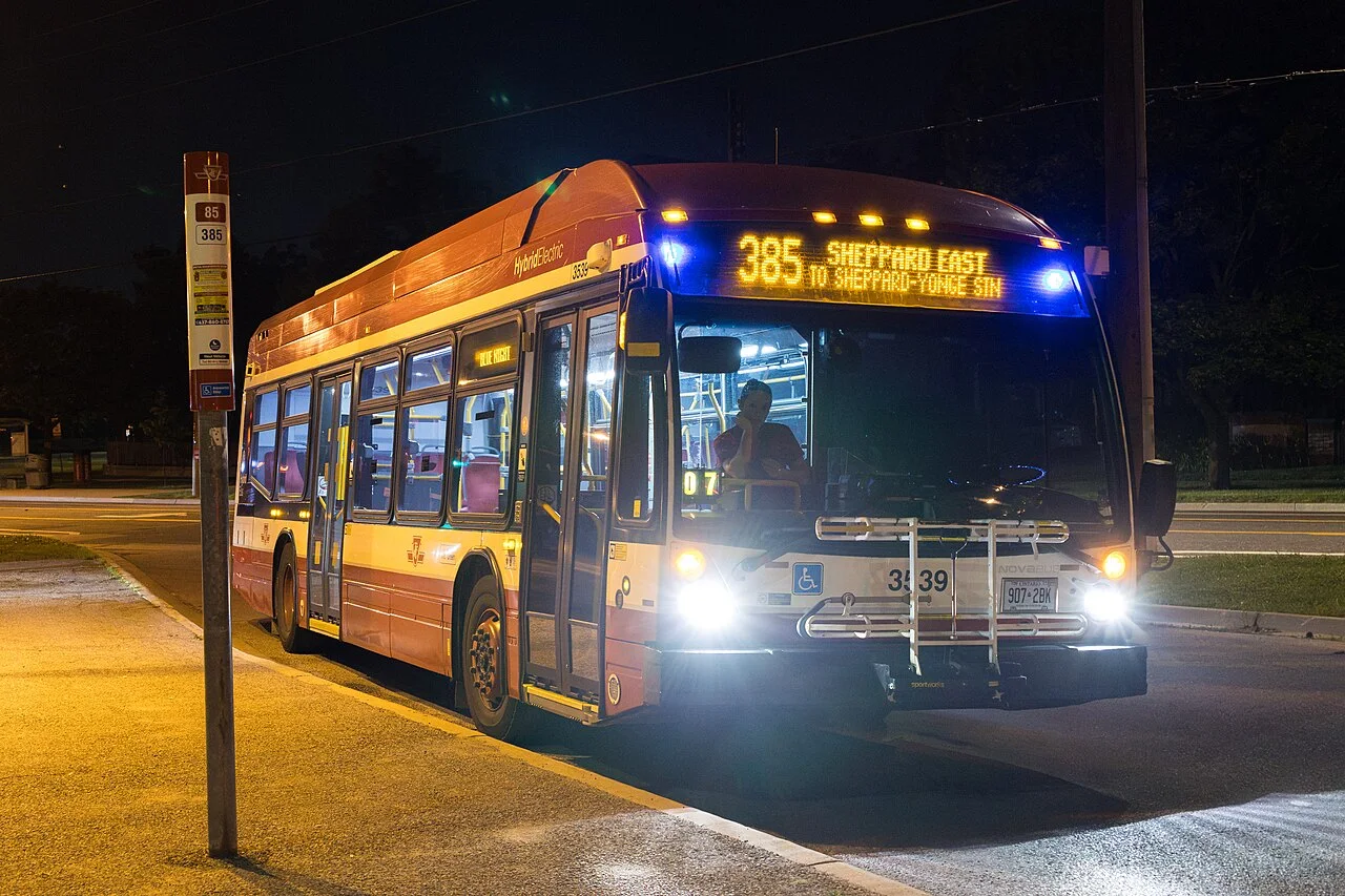 A TTC bus displaying 385 Sheppard East at night.