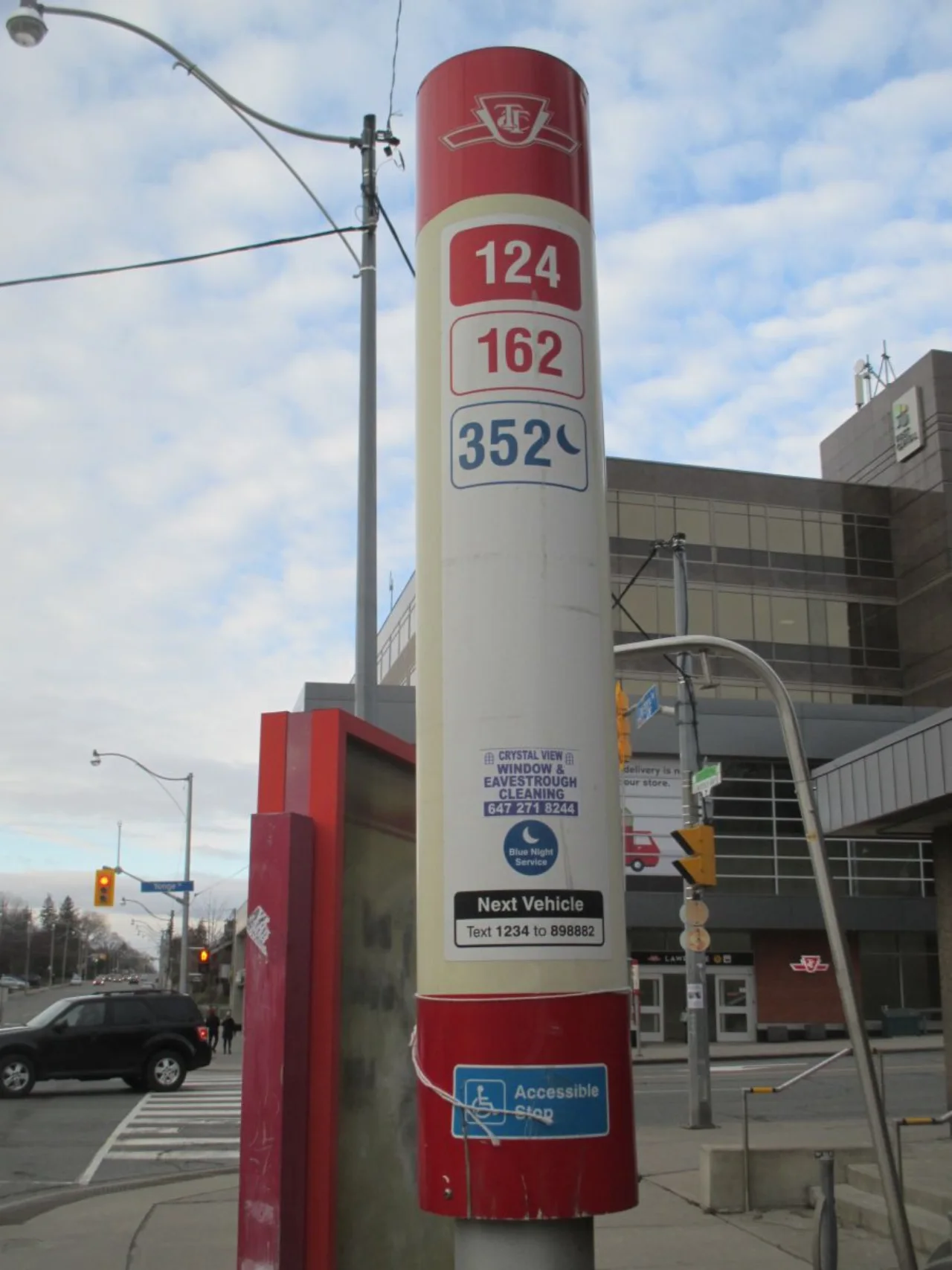 TTC stop pole with daytime route numbers and a blue night-route panel.
