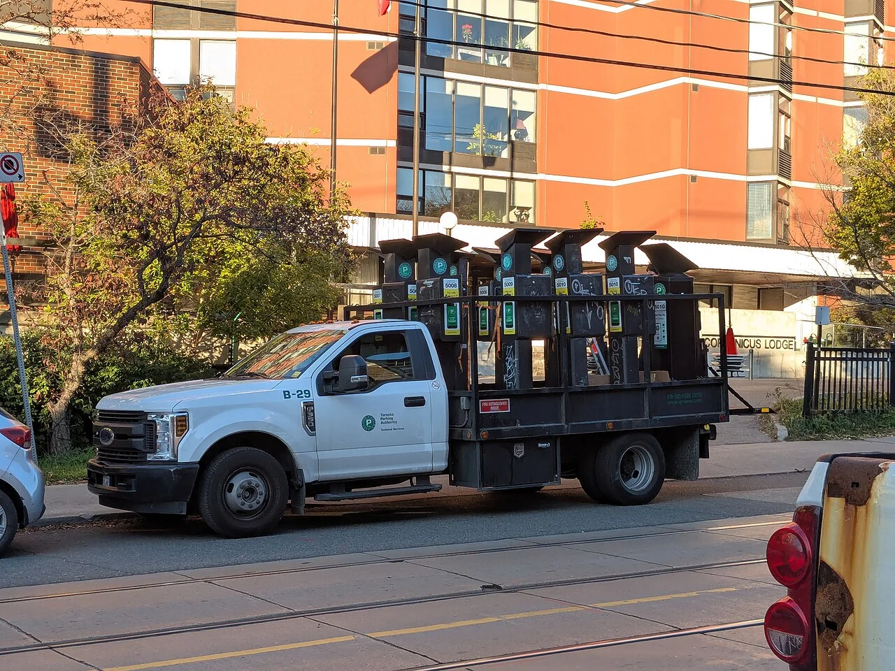 Removed parking meters loaded into a work truck on Roncesvalles Avenue.