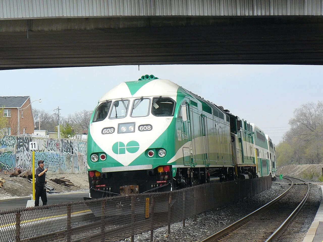 A GO train beside a station platform.