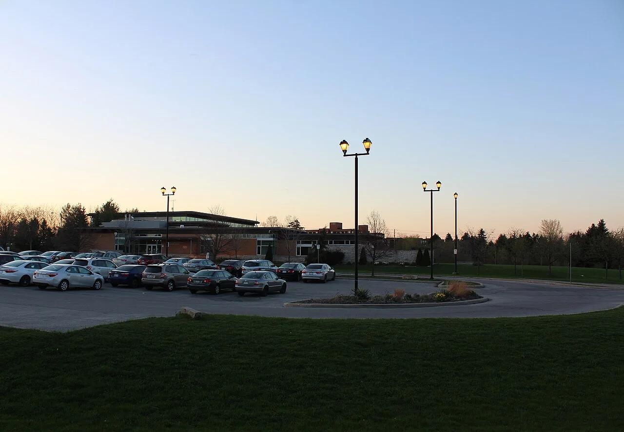 Milliken Park Community Recreation Centre and its parking area at dusk.
