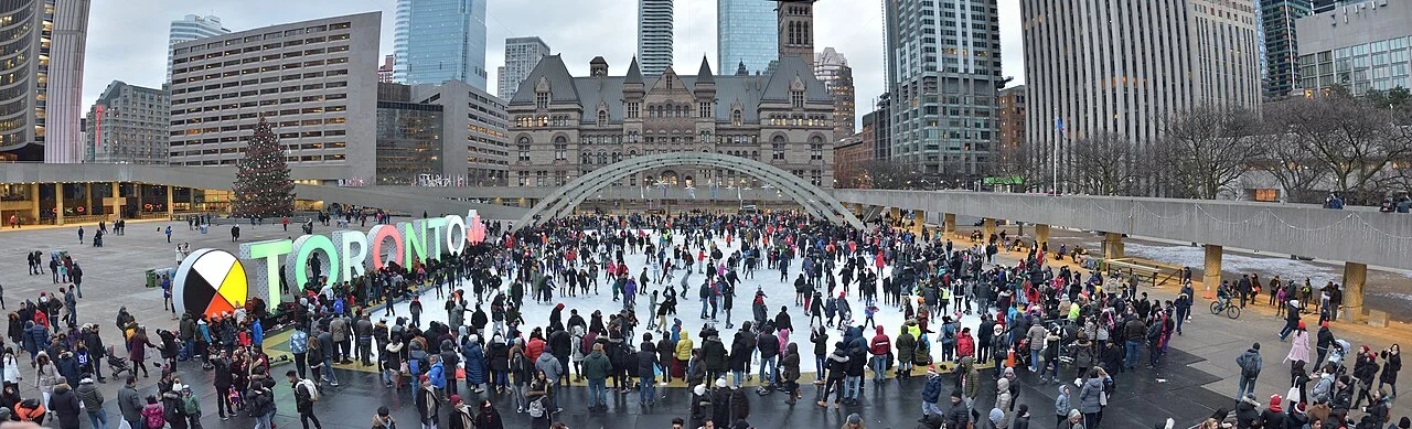 A wide view of skaters and City Hall at Nathan Phillips Square.