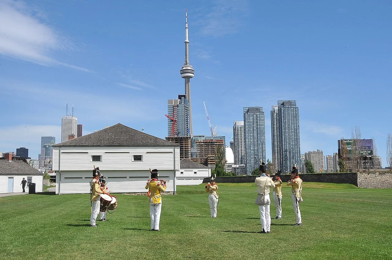 Fort York grounds with Toronto buildings behind them.
