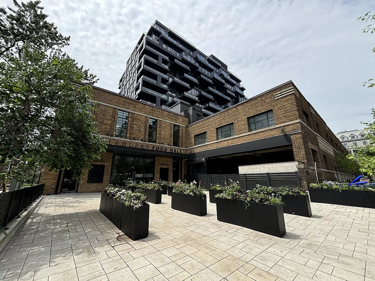 The brick entrance and courtyard planters outside Waterworks Food Hall in Toronto.